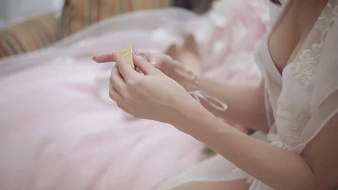 Closeup of a bride using perfume on her wedding day Stock-Footage 83994935