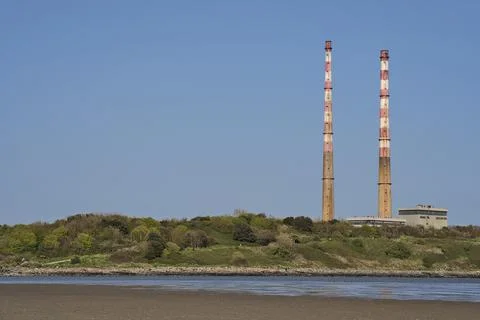 Closeup bright view of iconic Poolbeg CCGT station chimneys against clear sky Stock Photos
