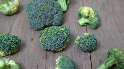 Closeup broccoli on wood background,pan in Stock Footage 232576562