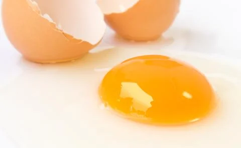 Closeup broken egg on white background Stock Photos