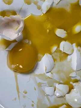 Closeup of broken eggs on white seamless background Fotos de archivo