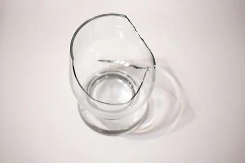 Closeup of broken transparent drinking glass in the kitchen Stock Photos