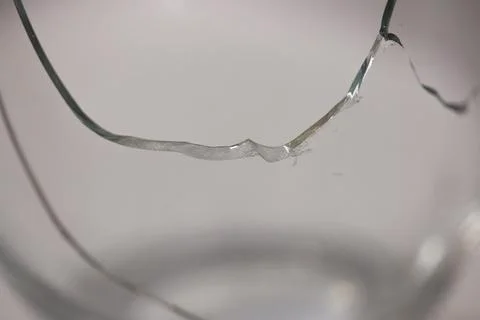 Closeup of broken transparent drinking glass in the kitchen Stock Photos