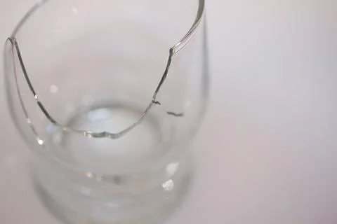 Closeup of broken transparent drinking glass in the kitchen Stock Photos