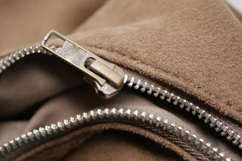 Closeup of broken zipper of a brown bag. Stock Photos