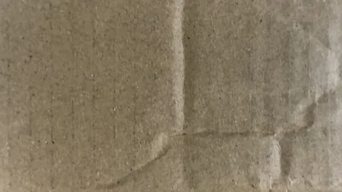 Closeup of brown corrugated cardboard texture with visible creases Stock Footage 340581111