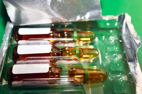 Closeup of Brown Empty Opened Glass Ampoule with White Labels Foto stock