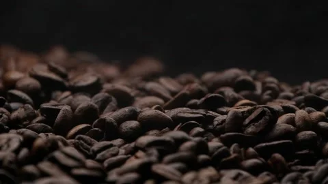 Closeup brown roasted coffee beans texture background with white steam or smoke Stock Footage 144199132