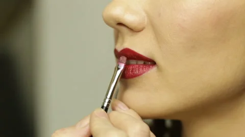 Closeup. Brushing red lips Stock Footage 63042372