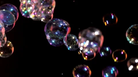 Closeup of bubbles blowing on black background Stock Footage 105836227