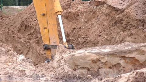 Closeup bucket of backhoe digging the soil at construction site Video stock 223817050