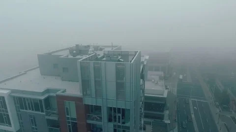 Closeup of the building in fog while tilting camera down Stockbeeldmateriaal 71725141