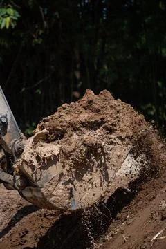 Closeup of bulldozer machine digging the ground and removing sand for excav.. 库存照片