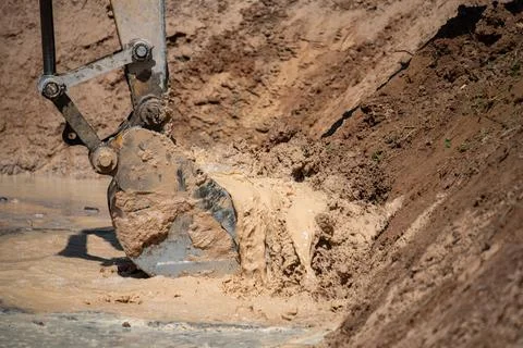 Closeup of bulldozer machine digging the ground and removing sand for excav.. 库存照片
