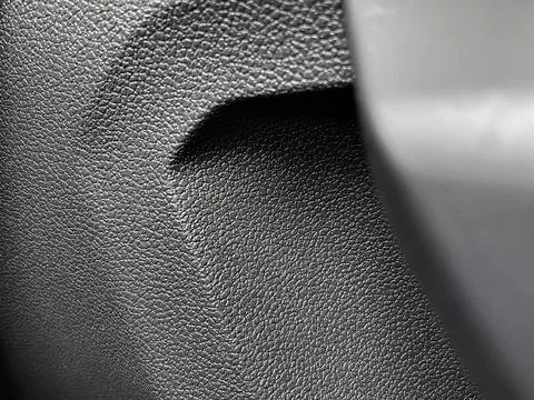 Closeup of the bumpy patterned gray plastic surface of a car's door Stock Photos
