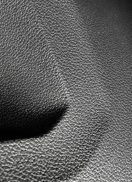 Closeup of the bumpy patterned gray plastic surface of a car's door Stockfoto's