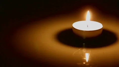 Closeup of burning candle on black. Stock Footage 74503383