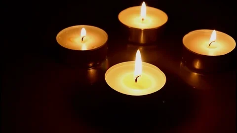 Closeup of burning candles with reflection on dark wooden table background Stock Footage 74503854