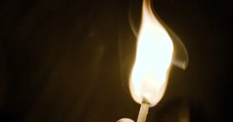 A closeup of a burning match in the night - 4k Stock Footage 67727697