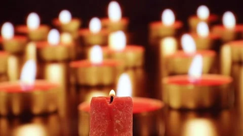 Closeup of burning red candle among many others in church or Buddhist temple Stock Footage 151762033
