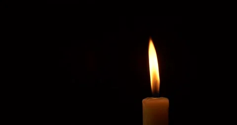 Closeup burning single candle flame isolated on black background Stock Footage 171787222