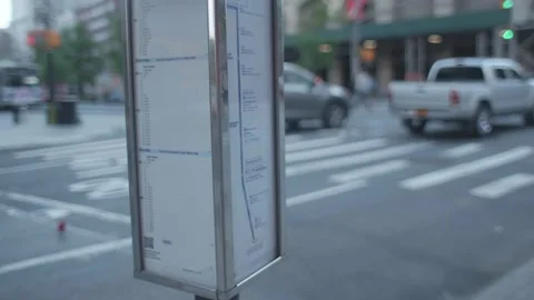 Closeup of Bus Schedule on Street Stock Footage 130485176