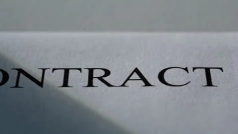 Closeup business document contract in sun beams. Paper with text for signing Stock Footage 332417229