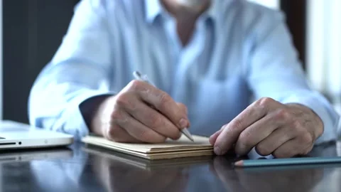 Closeup of business man hand write notes Stock Footage 132921042
