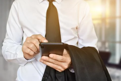 Closeup of businessman hand using mobile phone. Idea for business, technology Stock Photos
