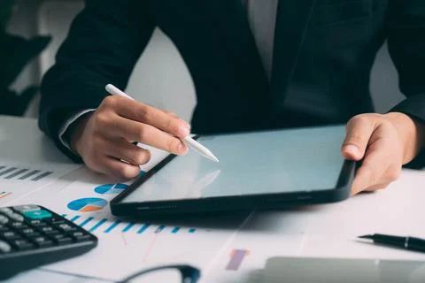 Closeup businessman hand using tablet computer at work Stock Photos