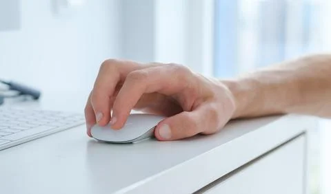 Closeup businessman using computer mouse with computer keyboard Stock Photos