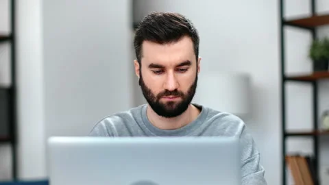 Closeup busy male programmer working on computer pc with confident face Stock Footage 175682975