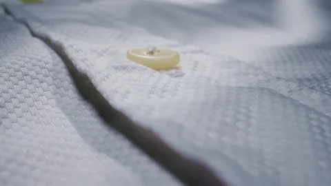 Closeup of a buttoned white textured shirt showcasing its intricate details and Stock Footage 281022852