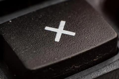 Closeup of a calculator keypad showcasing the multiplication button for Stock Photos