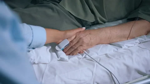 Closeup to the camera capturing video in the hospital old man laying down on the Video stock 209956877