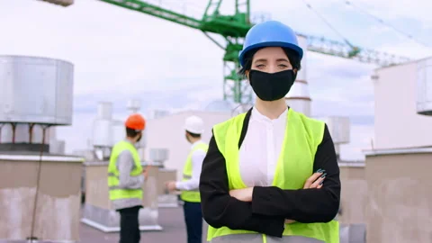 Closeup to the camera charismatic lady engineer with a protective mask and Stock Footage 138201891