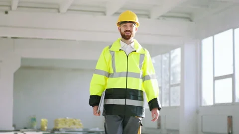 Closeup to the camera charismatic man architect holding laptop and analysing the Stock Footage 168633644