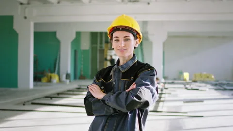 Closeup to the camera at construction site young woman engineer posing in front Stock Footage 199445486