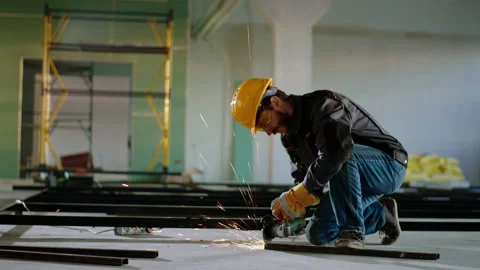 Closeup to the camera constructor worker using a disc welding machine cutting a Stock Footage 170152127