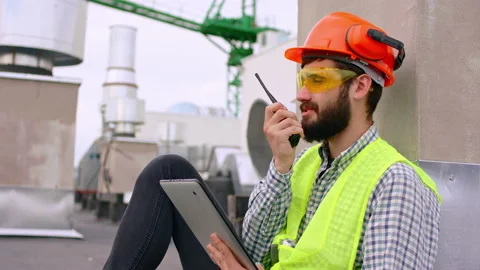 Closeup to the camera good looking man architect on the top of construction site Stock Footage 139824773