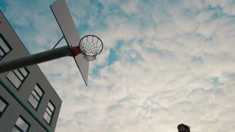 Closeup to the camera guy in a red sport suit playing basketball he throw the Stock Footage 168371406