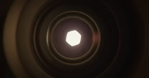 Closeup of Camera Lens Aperture Gradually Opening to Reveal Bright Light Stock Footage 346651864