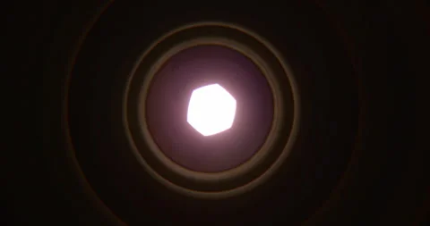 Closeup of Camera Lens Aperture Gradually Opening to Reveal Bright Light Stock Footage 346651904