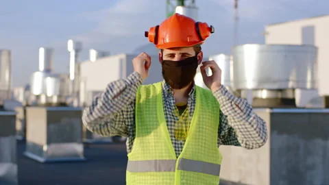 Closeup to the camera man engineer take the protective mask and put on his face Stock Footage 143160075
