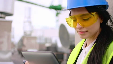Closeup to the camera with a protective eyeglasses and blue helmet make some Stock Footage 145216100
