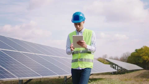 Closeup to the camera walking through power station engineer with digital tablet Stock Footage 163972721