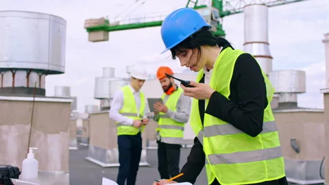 Closeup to the camera young lady engineer assistant take some notes while the Stock Footage 138199219