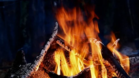 Closeup of Campfire Bonfire ablaze at night with red hot embers and coals. Stock Footage 99074372