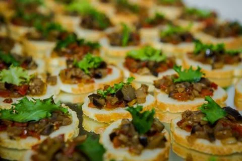 Closeup canape set with white bread and vegetable topping arranged in rows on 写真素材