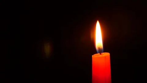 Closeup of candle on black. Dying out the flame of a white candle. Smoke from Stock Footage